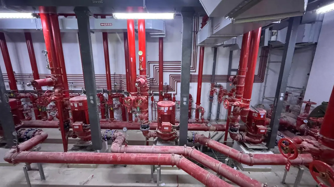 Riser main grid with overhead ductwork and cable trays at the installed fire pump room