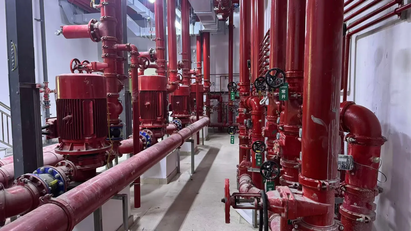 Gate valve train and gauges on red riser mains at the installed fire pump room